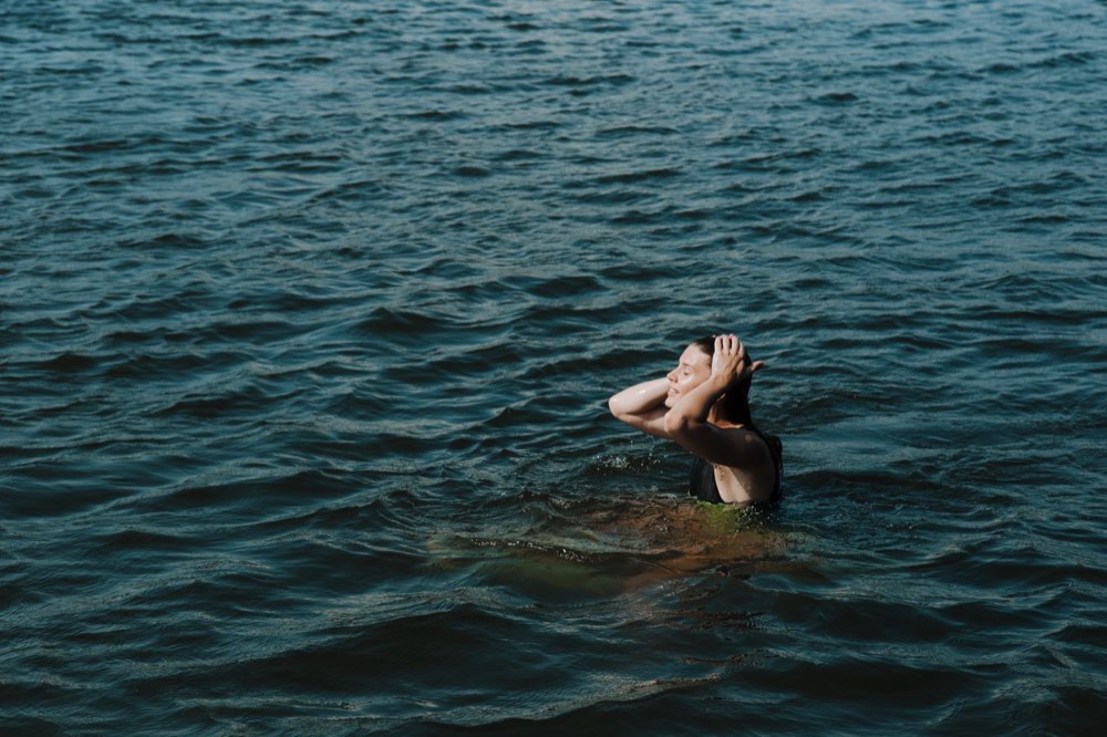 A swimmer in open water at first light